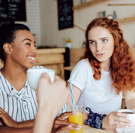 Friends in Conversation at Cafe
