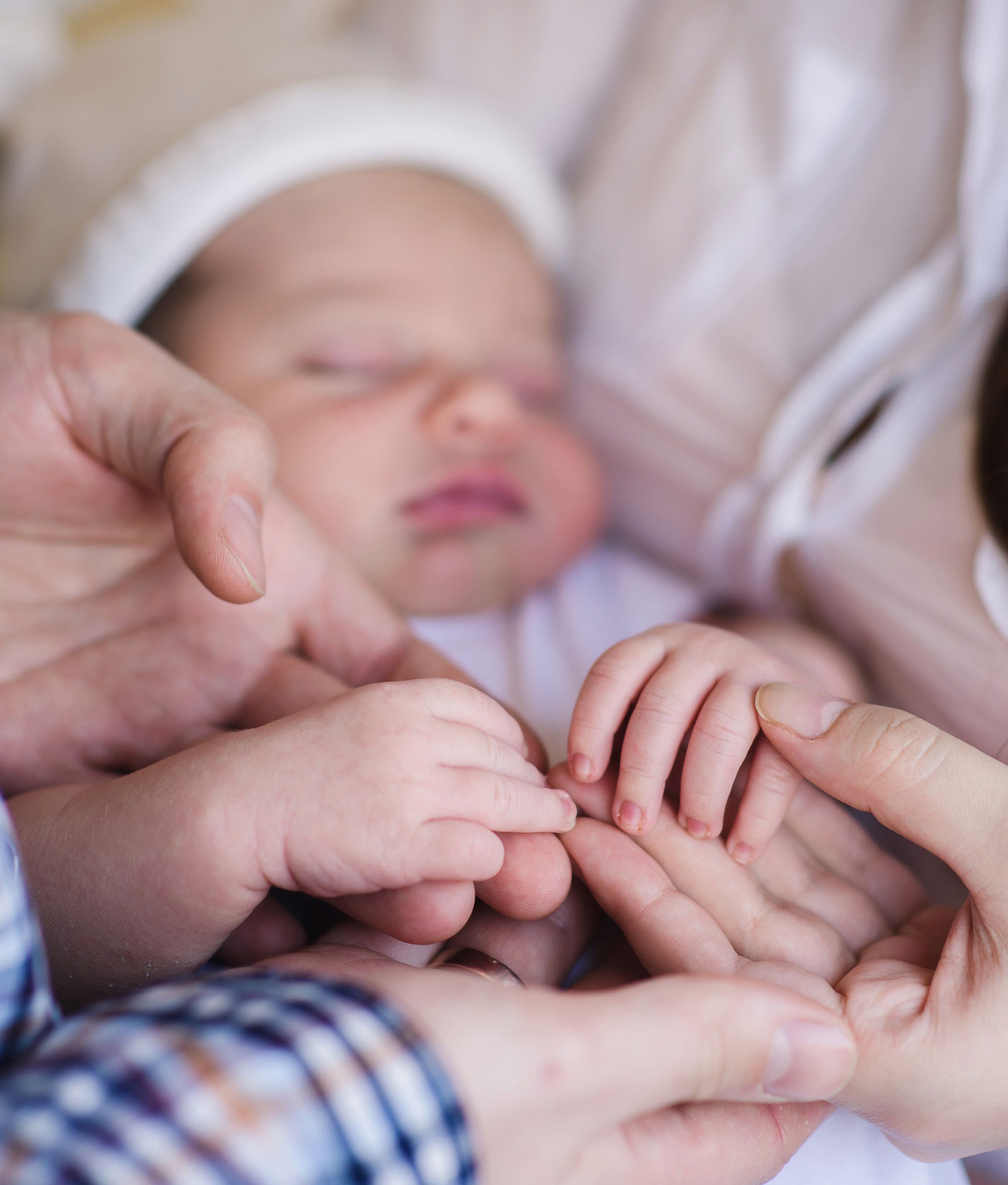 Parents Surrounding Newborn Baby